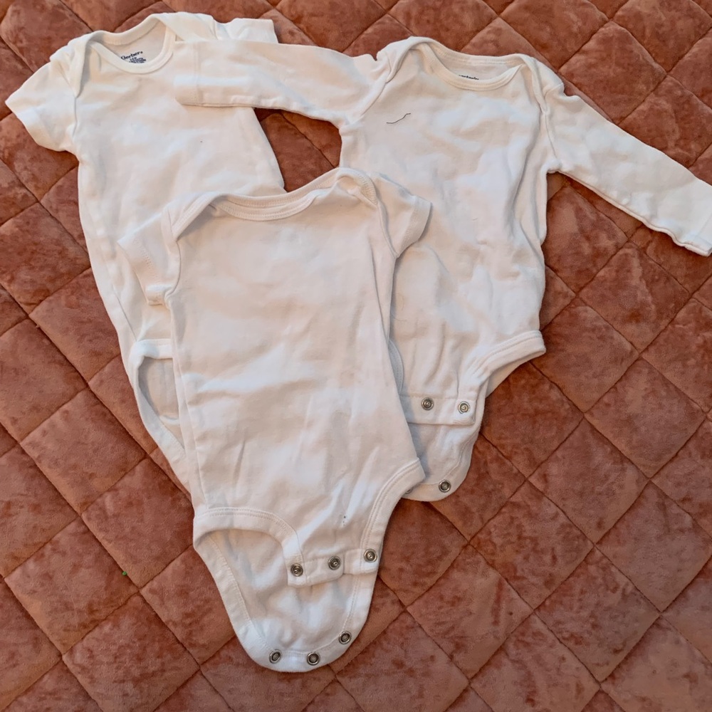 white baby onesies + swaddles